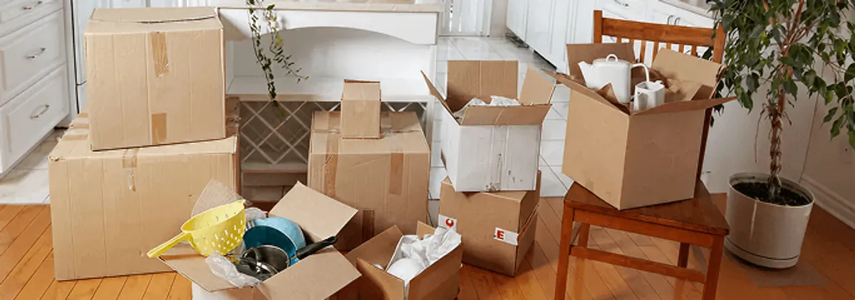 Packed moving boxes and household items in a kitchen before move-out or move-in cleaning, Arlington, TX.